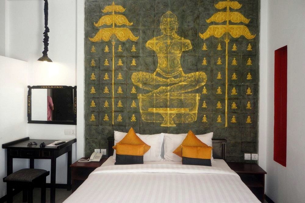 Hotel room with a gold Buddha mural